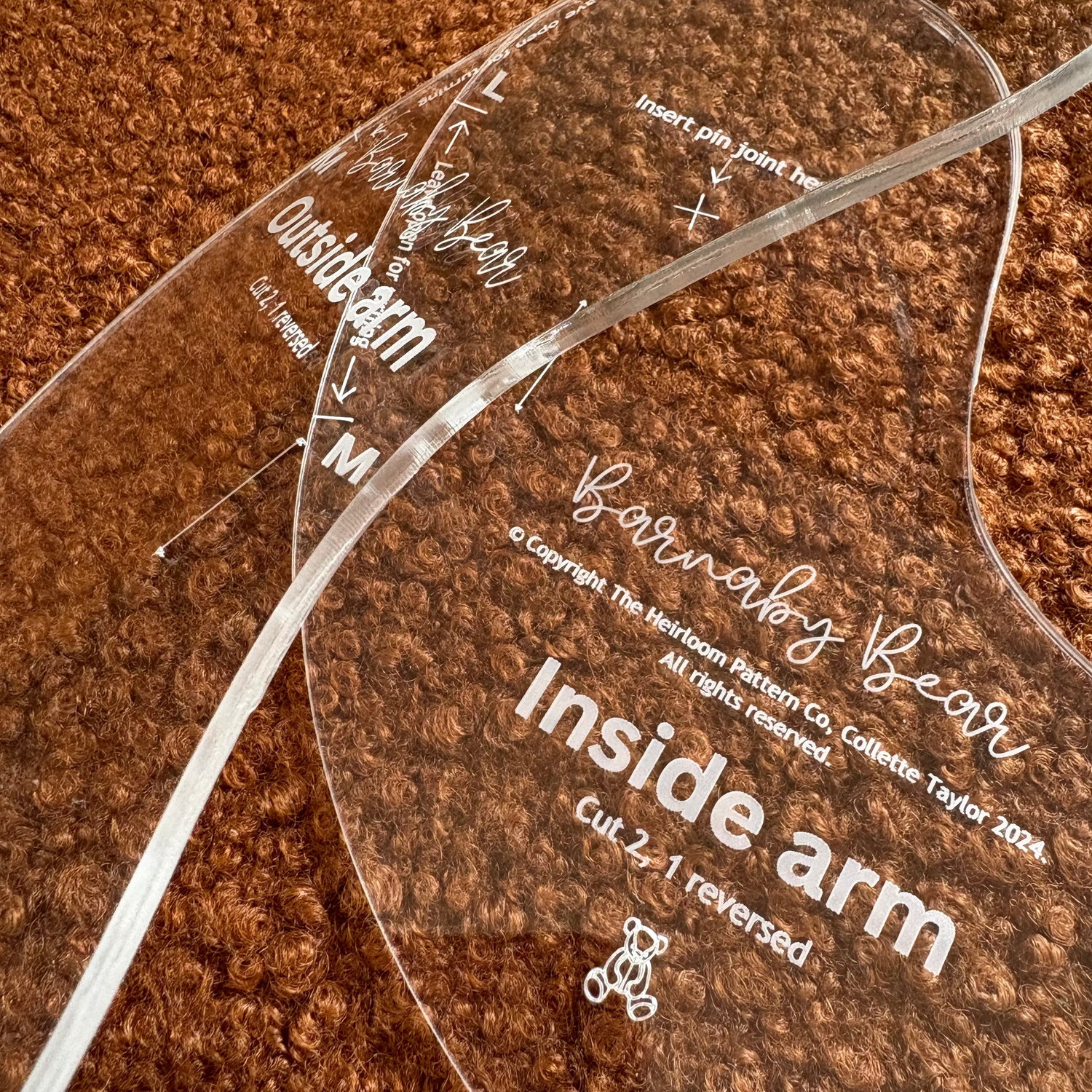 Clear acrylic Barnaby bear pattern guide with text on a brown textured background